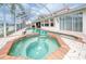 Sparkling pool and spa within a screened enclosure, providing a private and enjoyable outdoor oasis at 18002 Forest Retreat Ln, Tampa, FL 33647