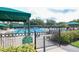 Community pool with a covered seating area and well-maintained deck, surrounded by lush greenery at 18002 Forest Retreat Ln, Tampa, FL 33647