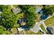 Aerial shot of a home's roof surrounded by trees and manicured lawn showcasing landscaping and neighborhood at 23253 Granite Pl, Land O Lakes, FL 34639