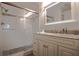 Modern bathroom featuring a glass shower with pebble floor and a granite vanity at 23253 Granite Pl, Land O Lakes, FL 34639