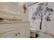 Cozy bathroom with a granite sink and a shower with a tree design curtain at 23253 Granite Pl, Land O Lakes, FL 34639