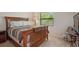 Cozy bedroom with a full size bed, a nightstand, and natural light at 23253 Granite Pl, Land O Lakes, FL 34639