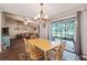Bright dining area features a chandelier, wood-look floors, and sliding doors to the patio at 23253 Granite Pl, Land O Lakes, FL 34639