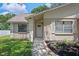 Inviting front entrance with a well-maintained yard and freshly painted exterior at 23253 Granite Pl, Land O Lakes, FL 34639