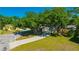 Mature trees shade a home with well-kept lawns, landscaping, and a long driveway at 23253 Granite Pl, Land O Lakes, FL 34639
