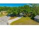 A well-manicured lawn features a home with mature trees, landscaping, and a long driveway at 23253 Granite Pl, Land O Lakes, FL 34639
