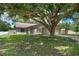 Charming single-story home with a well-manicured lawn and mature trees in a quiet neighborhood at 23253 Granite Pl, Land O Lakes, FL 34639