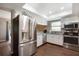 Bright kitchen featuring stainless steel appliances, granite countertops, and wood flooring at 23253 Granite Pl, Land O Lakes, FL 34639