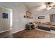 Comfortable living room with decor shelving, wood-look flooring, vaulted ceiling and neutral-toned walls at 23253 Granite Pl, Land O Lakes, FL 34639