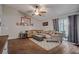 Living area features lots of natural light, wood-look floors, vaulted ceiling and neutral toned walls at 23253 Granite Pl, Land O Lakes, FL 34639