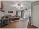 Bright living room adjacent to dining area featuring wood-look floors and vaulted ceiling at 23253 Granite Pl, Land O Lakes, FL 34639