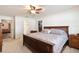Spacious bedroom with a ceiling fan, walk in closet, and neutral carpet at 23253 Granite Pl, Land O Lakes, FL 34639
