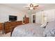 Spacious bedroom with a ceiling fan, walk in closet, and neutral carpet at 23253 Granite Pl, Land O Lakes, FL 34639