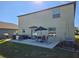 Backyard patio with dining set, seating area, grill, and lawn for outdoor enjoyment at 238 Argyll Dr, Spring Hill, FL 34609