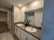 Bathroom featuring a granite countertop, double sinks, a large mirror, and a tile floor at 238 Argyll Dr, Spring Hill, FL 34609