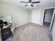 Bedroom featuring a ceiling fan, carpeted floors, closet, and a small desk with shelving at 238 Argyll Dr, Spring Hill, FL 34609