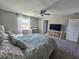 Bedroom featuring a ceiling fan, carpeted floors, TV with shelving and a queen size bed at 238 Argyll Dr, Spring Hill, FL 34609