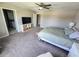 Bedroom featuring a ceiling fan, carpeted floors, TV with shelving and a queen size bed at 238 Argyll Dr, Spring Hill, FL 34609