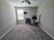 Bedroom featuring a ceiling fan, carpeted floors, a window, and a small desk with shelving at 238 Argyll Dr, Spring Hill, FL 34609