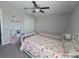 Bright bedroom featuring two twin beds, a ceiling fan, and a cozy, carpeted floor at 238 Argyll Dr, Spring Hill, FL 34609