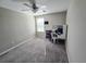 Bedroom featuring a ceiling fan, carpeted floors, a window, and a small desk with shelving at 238 Argyll Dr, Spring Hill, FL 34609