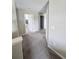 Well-lit hallway with neutral-toned walls and carpeting at 238 Argyll Dr, Spring Hill, FL 34609