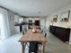Open-concept kitchen with island and seating, adjacent to a dining area, featuring modern cabinets and tile floors at 238 Argyll Dr, Spring Hill, FL 34609