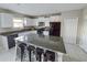 Modern kitchen featuring granite countertops, a large island with seating, and stainless steel appliances at 238 Argyll Dr, Spring Hill, FL 34609