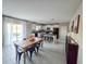 Open-concept kitchen with island and seating, adjacent to a dining area, featuring modern cabinets and tile floors at 238 Argyll Dr, Spring Hill, FL 34609