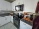 Modern kitchen with granite counters, stainless appliances, and white cabinetry at 238 Argyll Dr, Spring Hill, FL 34609