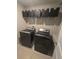 Modern laundry room with new washer and dryer and storage baskets at 238 Argyll Dr, Spring Hill, FL 34609