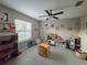 Bright living area with ceiling fan, window, tile flooring, and furniture for activities at 238 Argyll Dr, Spring Hill, FL 34609