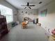 Bright living area with ceiling fan, window, tile flooring, and furniture for activities at 238 Argyll Dr, Spring Hill, FL 34609