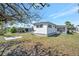 Exterior view of cozy home with a quaint patio and view of a well maintained lawn at 264 S Port Royal Ln, Apollo Beach, FL 33572