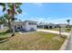 Charming home exterior with a well manicured front lawn and mature palm trees at 264 S Port Royal Ln, Apollo Beach, FL 33572