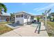 Charming single-story home featuring a covered carport and inviting outdoor seating area at 264 S Port Royal Ln, Apollo Beach, FL 33572