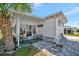 Charming home exterior with a cozy seating area and beautifully paved patio at 264 S Port Royal Ln, Apollo Beach, FL 33572
