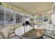 Enclosed Florida room with ample seating and views of the outdoors, perfect for relaxation and entertaining at 264 S Port Royal Ln, Apollo Beach, FL 33572