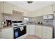 Functional kitchen featuring mosaic tile backsplash, sleek appliances, and bright natural light from the window at 264 S Port Royal Ln, Apollo Beach, FL 33572