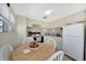 Bright kitchen with an oven, refrigerator, dining table and light colored cabinets at 264 S Port Royal Ln, Apollo Beach, FL 33572