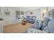 Cozy living room features wood-look floors and comfortable blue couches at 264 S Port Royal Ln, Apollo Beach, FL 33572