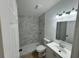 Modern bathroom showcasing a tiled shower, and stylish vanity with ample lighting at 26448 Eager Rd, Punta Gorda, FL 33955
