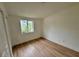 Serene bedroom with a large window offering scenic views and new floors at 26448 Eager Rd, Punta Gorda, FL 33955