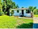 Charming single-story home features a well-maintained lawn and beautiful landscaping at 26448 Eager Rd, Punta Gorda, FL 33955