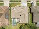 An aerial view of the home shows a screened-in pool and generous lawn at 28451 Great Bend Pl, Wesley Chapel, FL 33543