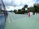 Community basketball court with white lines, bright green surface and covered bleachers at 28451 Great Bend Pl, Wesley Chapel, FL 33543
