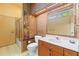 Bathroom showcasing unique mosaic tile walls, vanity with marble countertop, and shower with glass doors at 28451 Great Bend Pl, Wesley Chapel, FL 33543