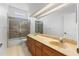 Bathroom featuring double sinks with matching cabinets and a glass enclosed shower at 28451 Great Bend Pl, Wesley Chapel, FL 33543
