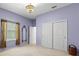Bright bedroom features a decorative light fixture, a large window and a closet with white doors at 28451 Great Bend Pl, Wesley Chapel, FL 33543