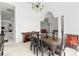 Open-concept dining area with dark wood furniture, seamlessly flowing into the living spaces at 28451 Great Bend Pl, Wesley Chapel, FL 33543